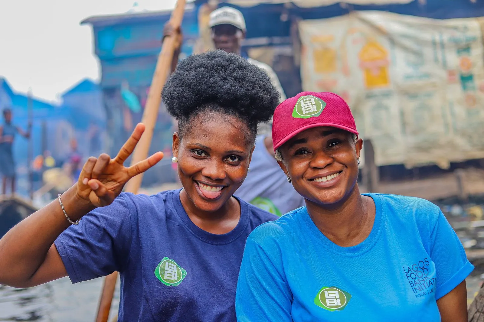 Volunteers in blue shirts smiling