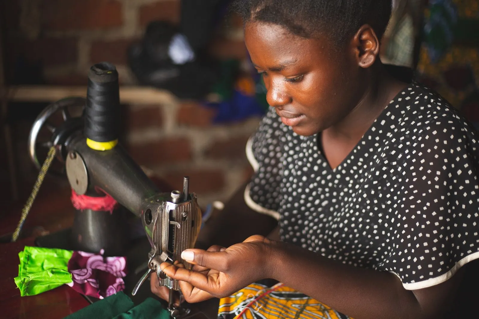 A young woman at a sewing machine