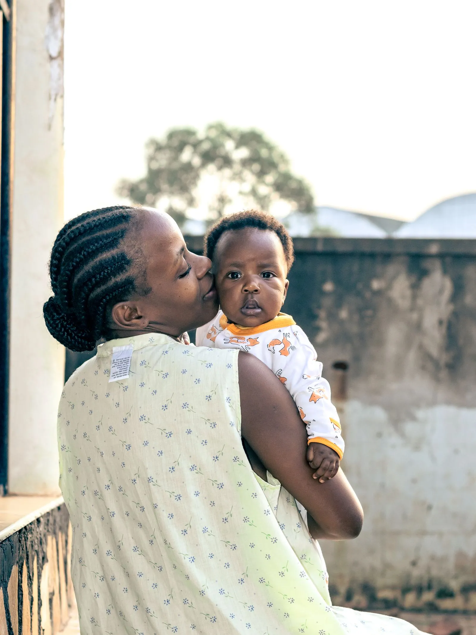 A young mother holding her baby
